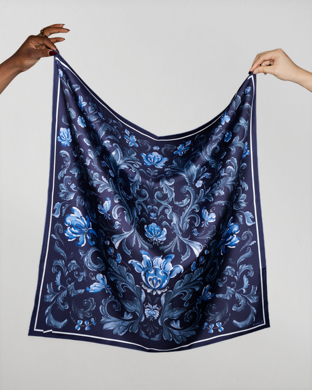 Månerose silk twill scarf held up by hand to show the drape