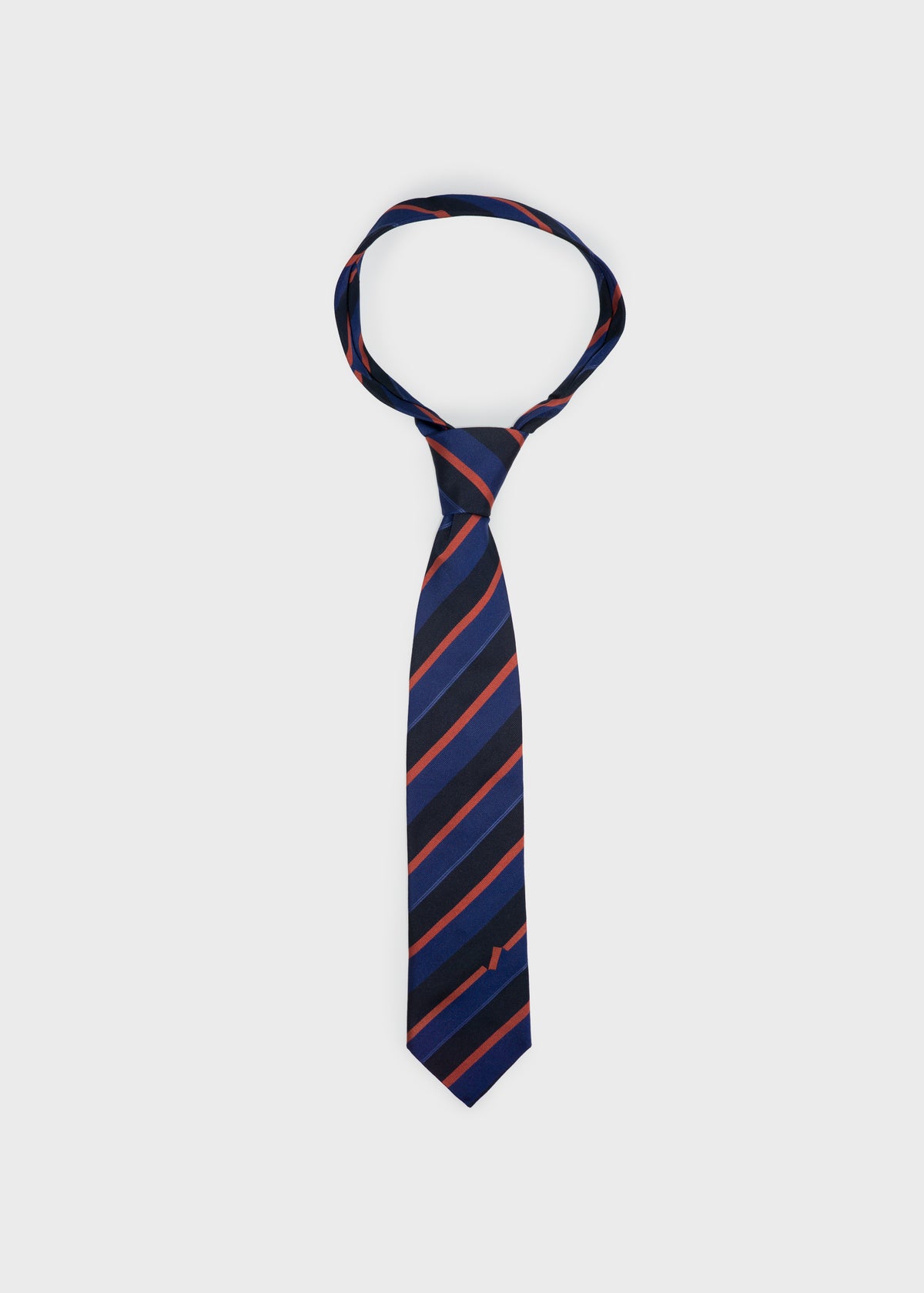 Accent silk tie in navy and red stripe, tied in a knot